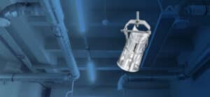 Metal clamp on industrial ductwork ceiling.