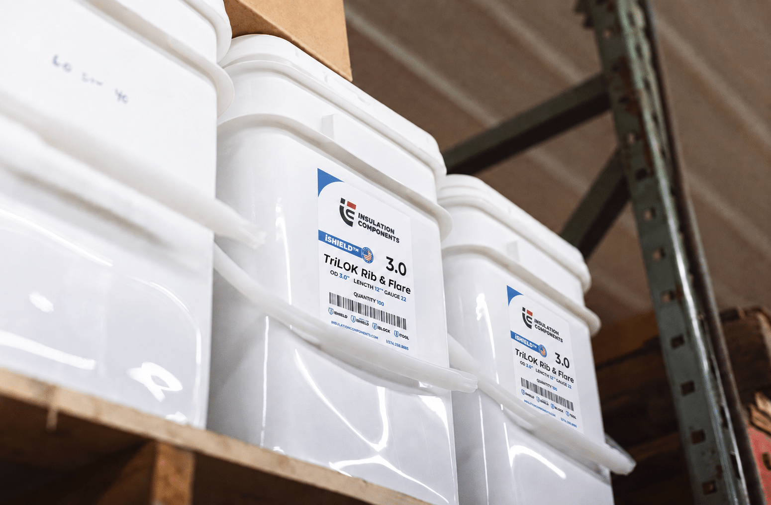 White insulation component containers stacked on warehouse shelf